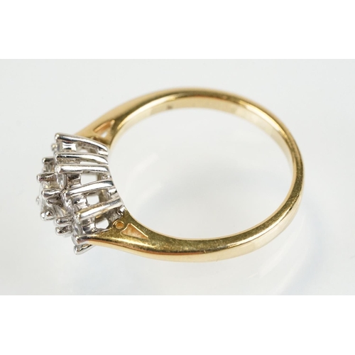 278 - 9ct gold and diamond cluster ring being set with three baguette cut diamonds surrounded by twelve ro... 