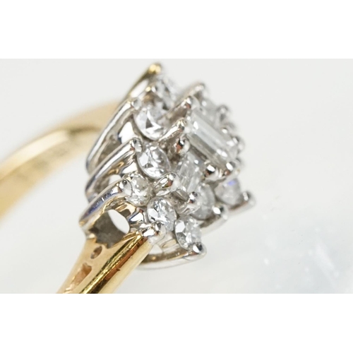 278 - 9ct gold and diamond cluster ring being set with three baguette cut diamonds surrounded by twelve ro... 