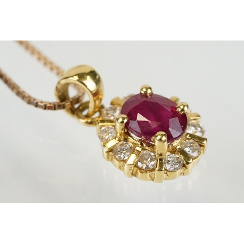 279 - 18ct gold pendant set with an oval cut ruby to centre with a halo of round cut diamonds. Pendant wit... 