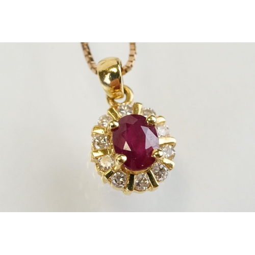 279 - 18ct gold pendant set with an oval cut ruby to centre with a halo of round cut diamonds. Pendant wit... 