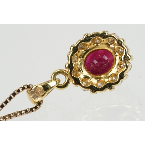 279 - 18ct gold pendant set with an oval cut ruby to centre with a halo of round cut diamonds. Pendant wit... 