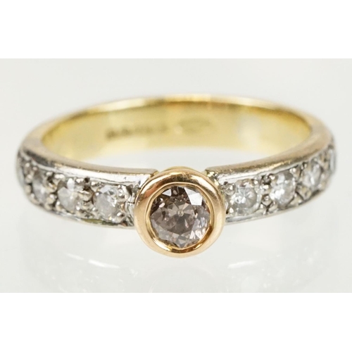 288 - 18ct gold tri tone diamond ring having a central round cut diamond set in a bezel setting with diamo... 