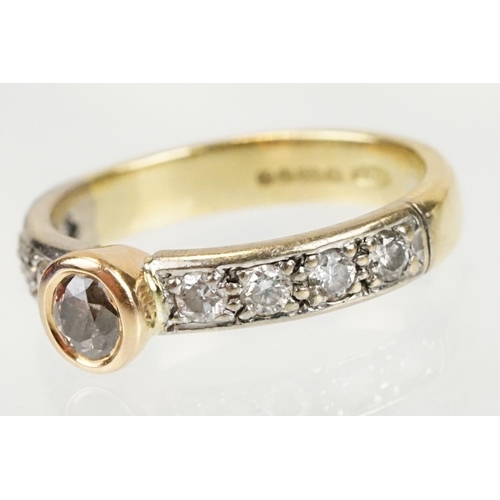 288 - 18ct gold tri tone diamond ring having a central round cut diamond set in a bezel setting with diamo... 