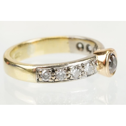 288 - 18ct gold tri tone diamond ring having a central round cut diamond set in a bezel setting with diamo... 