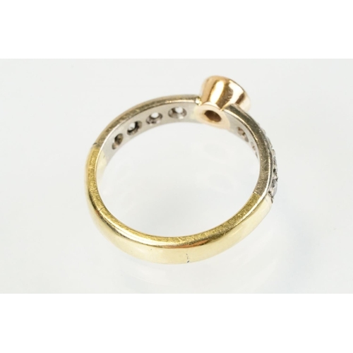 288 - 18ct gold tri tone diamond ring having a central round cut diamond set in a bezel setting with diamo... 