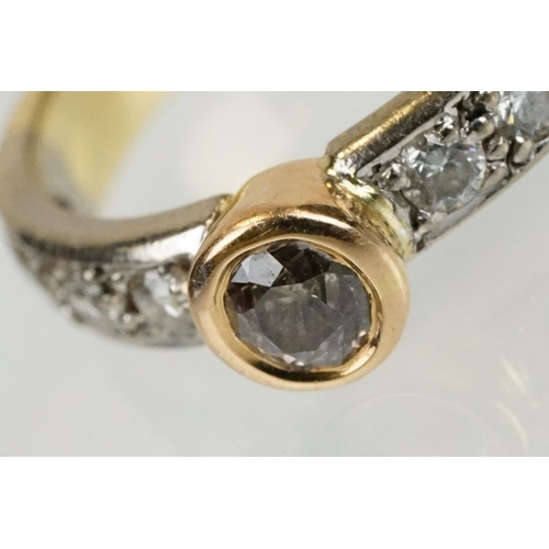 288 - 18ct gold tri tone diamond ring having a central round cut diamond set in a bezel setting with diamo... 