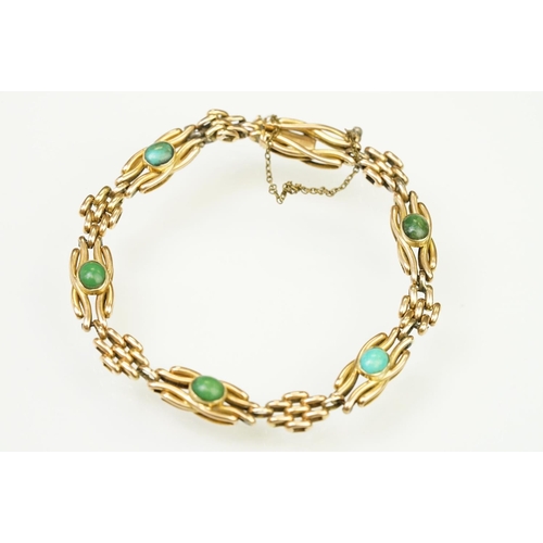 29 - 15ct gold and turquoise gate link bracelet. The bracelet being beze set with five oval turquoise cab... 