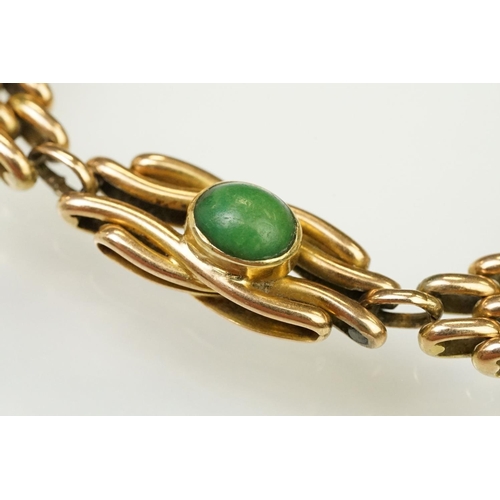 29 - 15ct gold and turquoise gate link bracelet. The bracelet being beze set with five oval turquoise cab... 