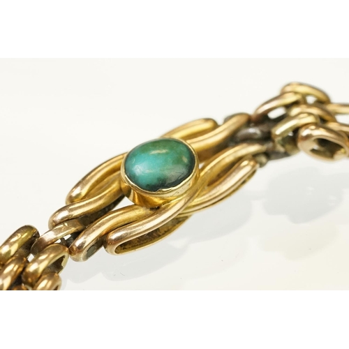 29 - 15ct gold and turquoise gate link bracelet. The bracelet being beze set with five oval turquoise cab... 