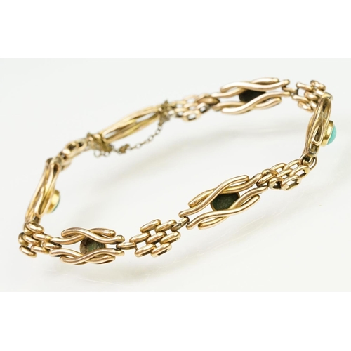 29 - 15ct gold and turquoise gate link bracelet. The bracelet being beze set with five oval turquoise cab... 