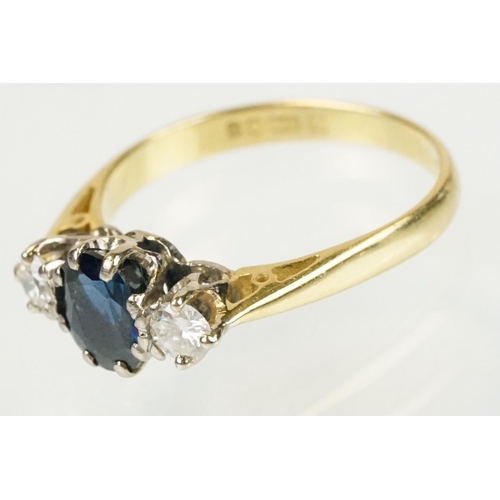 292 - 18ct gold sapphire and diamond three stone ring. The ring being set with an oval cut sapphire flanke... 