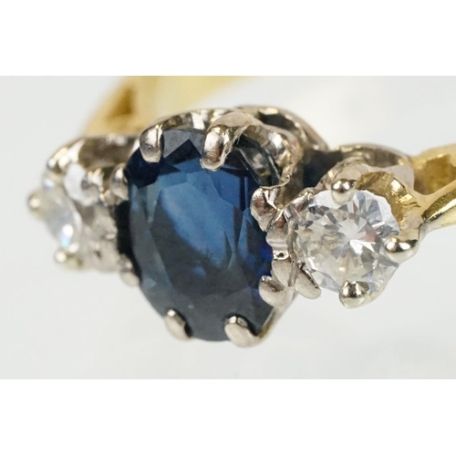 292 - 18ct gold sapphire and diamond three stone ring. The ring being set with an oval cut sapphire flanke... 