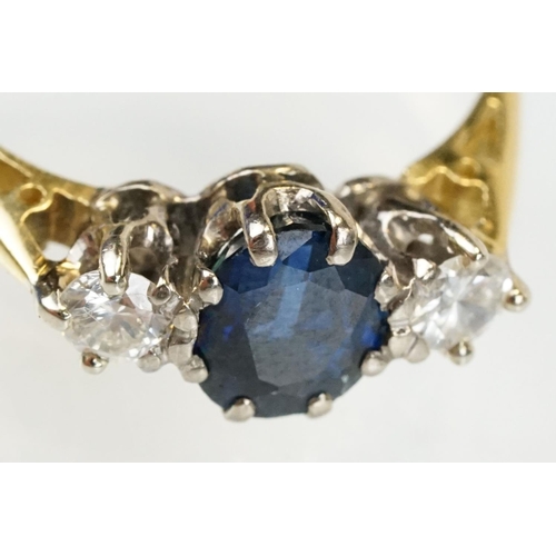 292 - 18ct gold sapphire and diamond three stone ring. The ring being set with an oval cut sapphire flanke... 