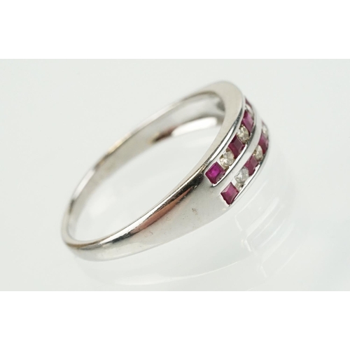 295 - 14ct white gold diamond and ruby double line ring being channel set with eight round brilliant cut r... 