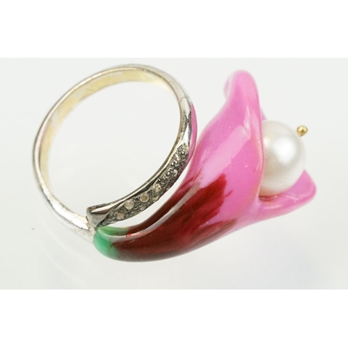 306 - Enamelled flower formed ring being set with a cultured pearl to the head with diamond accent stones ... 