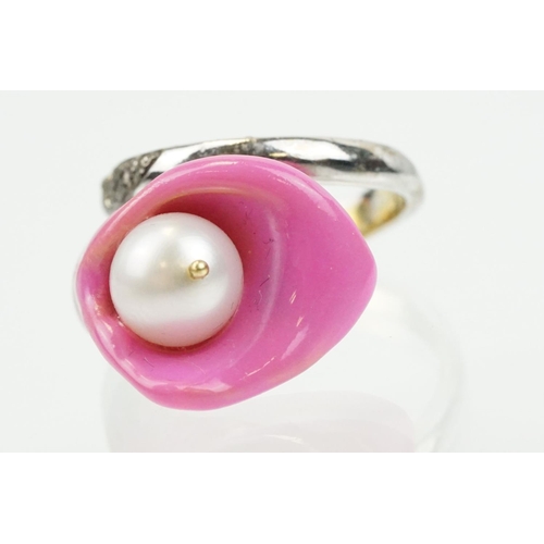 306 - Enamelled flower formed ring being set with a cultured pearl to the head with diamond accent stones ... 