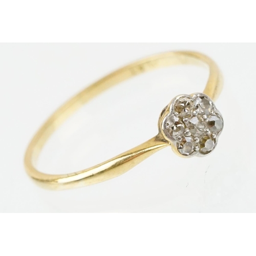 31 - 18ct gold and platinum diamond cluster daisy ring. The ring being set with seven single cut diamonds... 