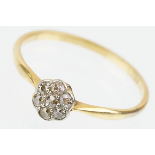 31 - 18ct gold and platinum diamond cluster daisy ring. The ring being set with seven single cut diamonds... 