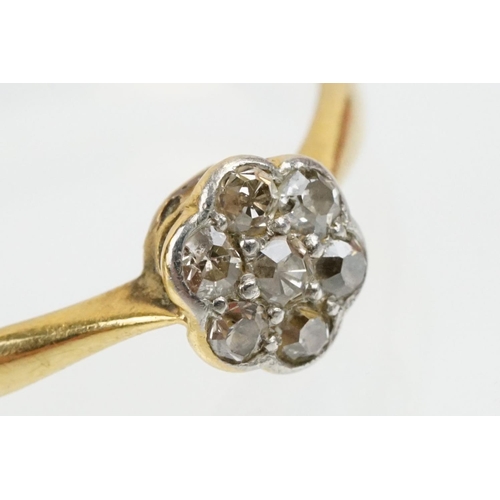 31 - 18ct gold and platinum diamond cluster daisy ring. The ring being set with seven single cut diamonds... 