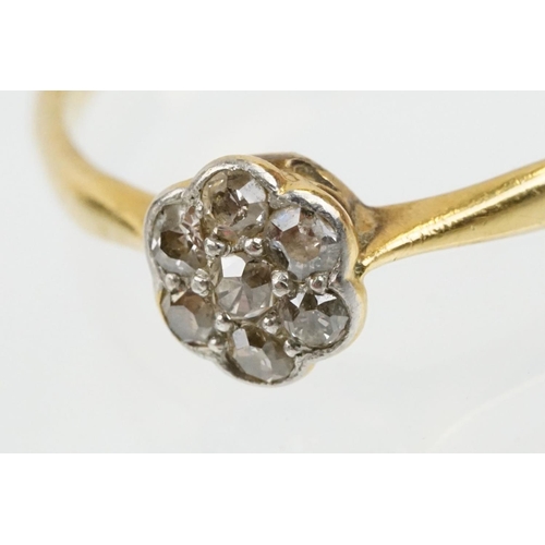 31 - 18ct gold and platinum diamond cluster daisy ring. The ring being set with seven single cut diamonds... 