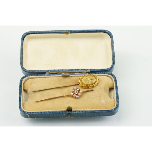 324 - Two 19th Century stick pins to include a diamond, coral and half pearl finial pin (unmarked) and an ... 