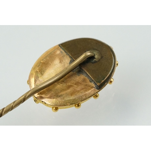 324 - Two 19th Century stick pins to include a diamond, coral and half pearl finial pin (unmarked) and an ... 