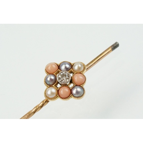 324 - Two 19th Century stick pins to include a diamond, coral and half pearl finial pin (unmarked) and an ... 