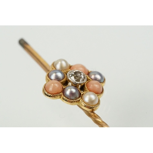 324 - Two 19th Century stick pins to include a diamond, coral and half pearl finial pin (unmarked) and an ... 