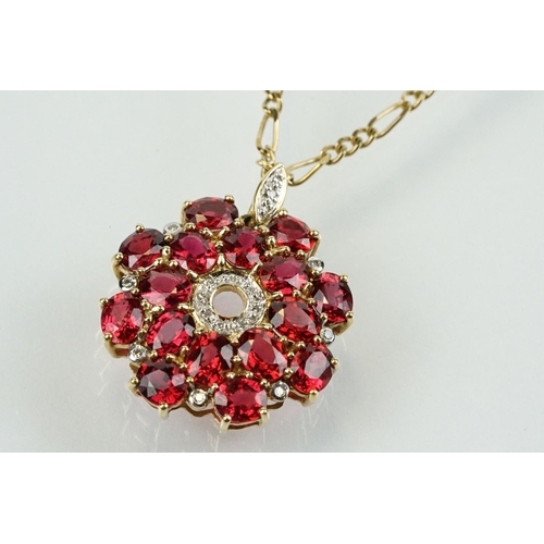 325 - 9ct gold ruby and diamond cluster pendant being set with sixteen oval cut rubies around a centre of ... 