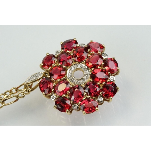 325 - 9ct gold ruby and diamond cluster pendant being set with sixteen oval cut rubies around a centre of ... 