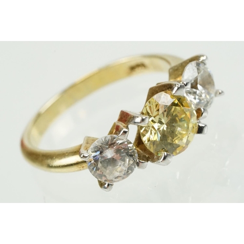 327 - Three stone dress ring being set with a yellow stone to centre flanked by two white stones in a yell... 