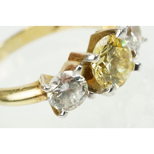 327 - Three stone dress ring being set with a yellow stone to centre flanked by two white stones in a yell... 