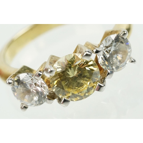 327 - Three stone dress ring being set with a yellow stone to centre flanked by two white stones in a yell... 