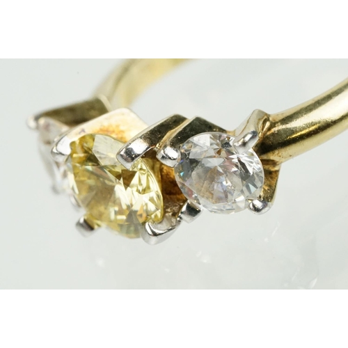 327 - Three stone dress ring being set with a yellow stone to centre flanked by two white stones in a yell... 