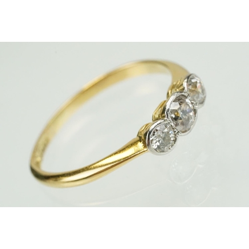 328 - 18ct gold and diamond three stone ring being set with three old cut diamonds in bezel settings. Band... 