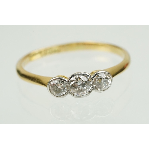 328 - 18ct gold and diamond three stone ring being set with three old cut diamonds in bezel settings. Band... 