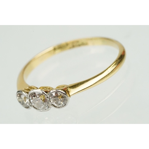 328 - 18ct gold and diamond three stone ring being set with three old cut diamonds in bezel settings. Band... 