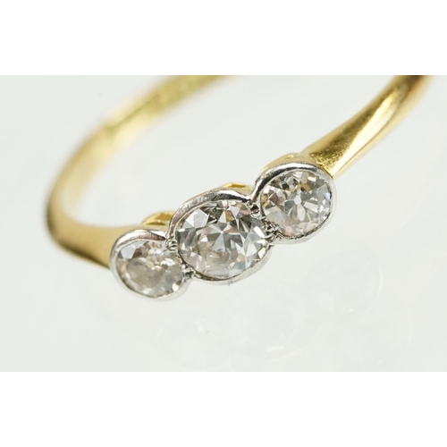 328 - 18ct gold and diamond three stone ring being set with three old cut diamonds in bezel settings. Band... 