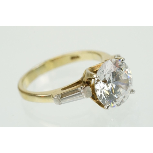 329 - Two white stone dress rings to include a solitaire ring having a round cut white stone in a basket s... 