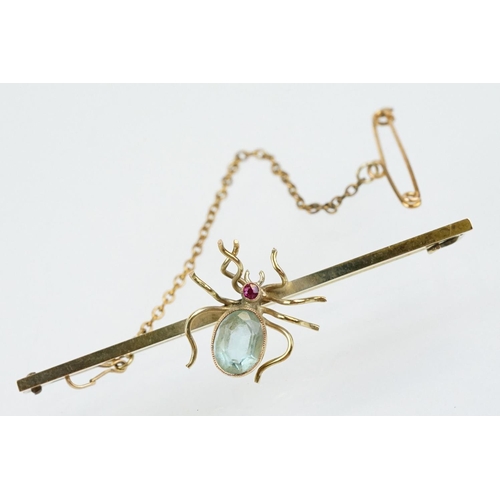 33 - 9ct gold and aquamarine bar brooch being set with a brooch to centre having an oval cut aquamarine s... 