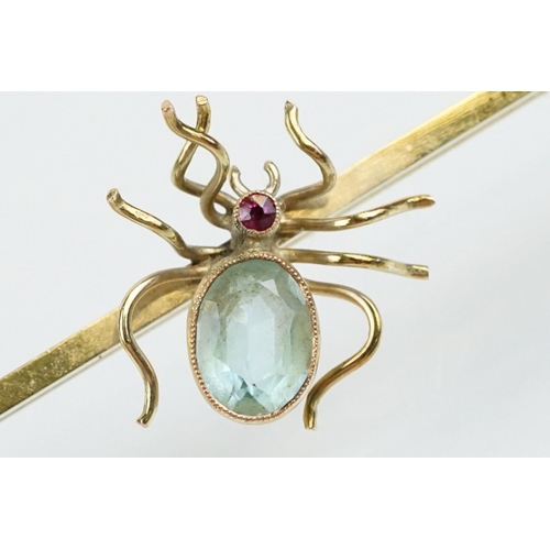 33 - 9ct gold and aquamarine bar brooch being set with a brooch to centre having an oval cut aquamarine s... 