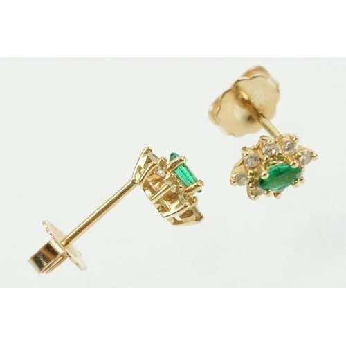 333 - Pair of 14ct gold, emerald and diamond cluster earrings. The each set with a central marquise cut em... 