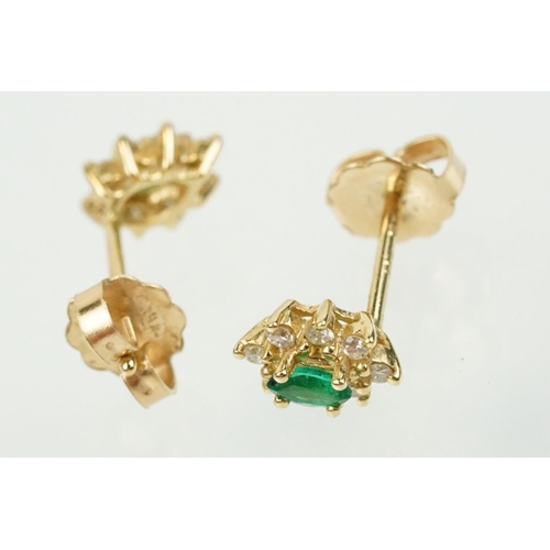 333 - Pair of 14ct gold, emerald and diamond cluster earrings. The each set with a central marquise cut em... 