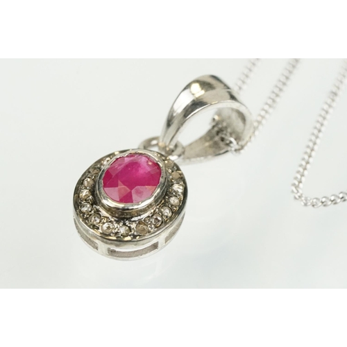 338 - Ruby and diamond pendant having an oval cut ruby to centre with a halo of diamonds to the mount. Bal... 