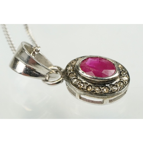 338 - Ruby and diamond pendant having an oval cut ruby to centre with a halo of diamonds to the mount. Bal... 