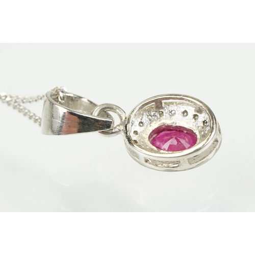 338 - Ruby and diamond pendant having an oval cut ruby to centre with a halo of diamonds to the mount. Bal... 