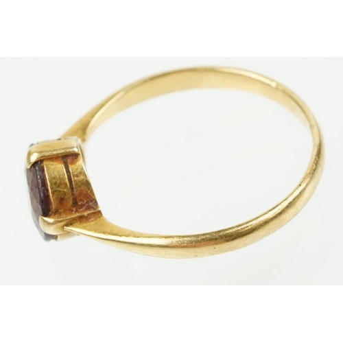 341 - 18ct gold and purple stone ring being having a round cut purple stone in a four prong setting (marke... 