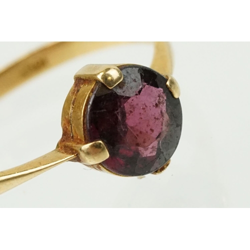 341 - 18ct gold and purple stone ring being having a round cut purple stone in a four prong setting (marke... 