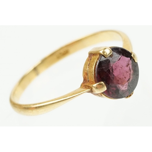 341 - 18ct gold and purple stone ring being having a round cut purple stone in a four prong setting (marke... 