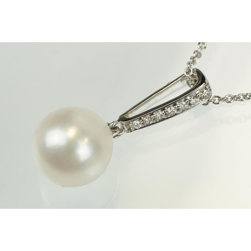 342 - Cultured pearl and diamond pendant having a single spherical pearl with diamond accent stones to the... 